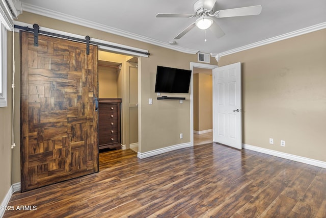 7250 E Mckellips Rd, Scottsdale, AZ 85257 - unfurnished bedroom featuring a barn door, wood finished floors, baseboards, crown molding, and a closet