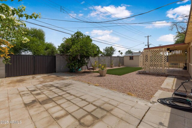 7250 E Mckellips Rd, Scottsdale, AZ 85257 - view of patio / terrace featuring a gate and an outbuilding