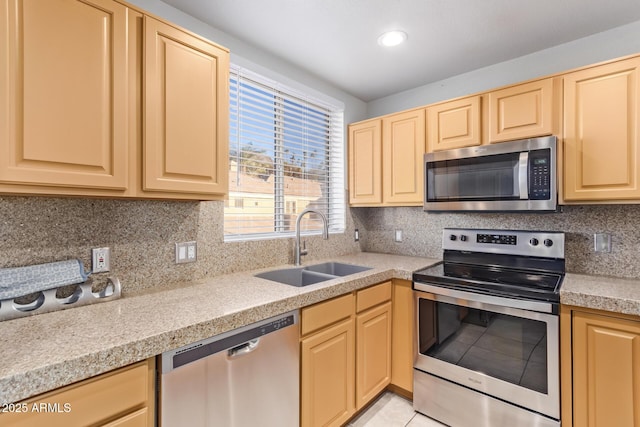 kitchen featuring light brown cabinetry, appliances with stainless steel finishes, and sink