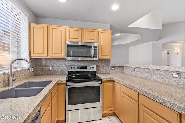 kitchen featuring a wealth of natural light, light brown cabinets, stainless steel appliances, sink, and light tile patterned flooring