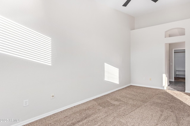 carpeted empty room featuring ceiling fan and plenty of natural light