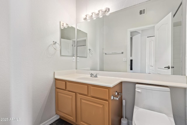 bathroom with toilet and vanity