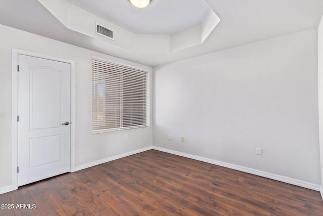 empty room featuring dark hardwood / wood-style flooring