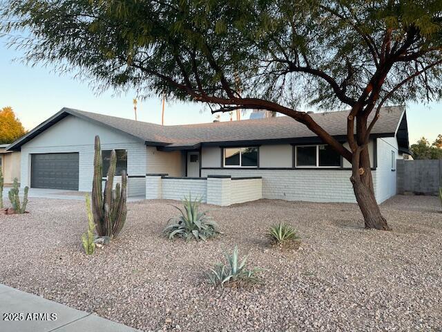 ranch-style home featuring a garage