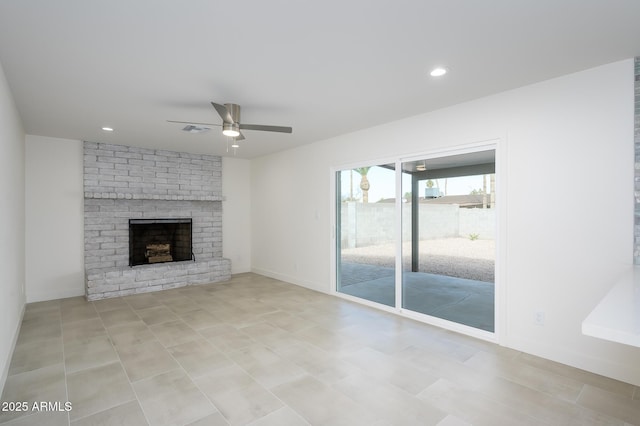 unfurnished living room featuring ceiling fan and a fireplace