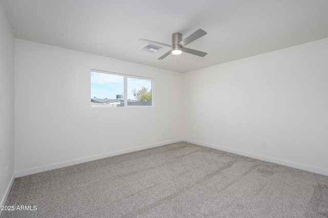 carpeted spare room featuring ceiling fan