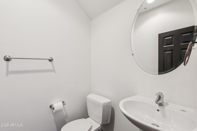 half bathroom with a sink and toilet