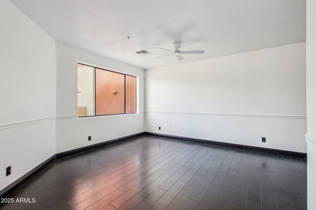 spare room with ceiling fan, wood finished floors, and baseboards