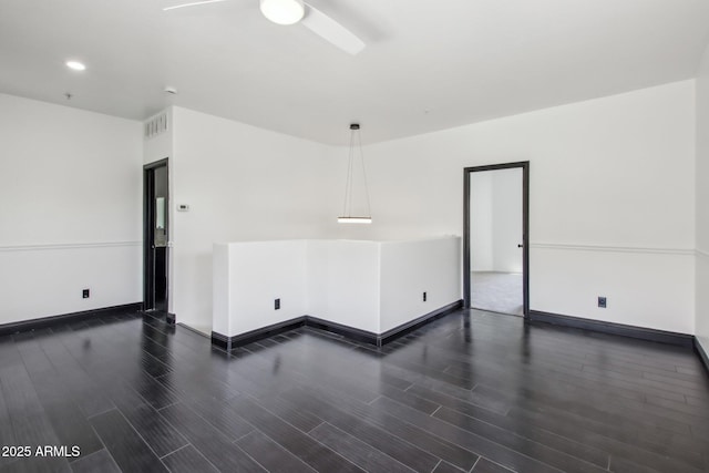 spare room featuring dark wood finished floors, ceiling fan, baseboards, and recessed lighting