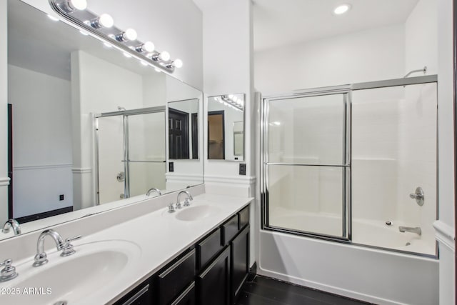 bathroom featuring bath / shower combo with glass door, double vanity, and recessed lighting