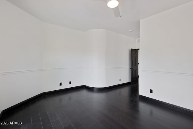 unfurnished room featuring wood finished floors, a ceiling fan, and baseboards