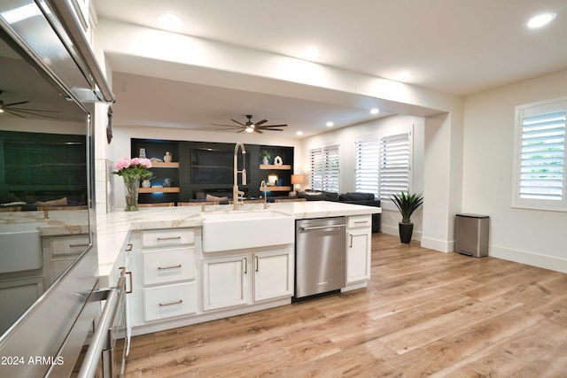 kitchen featuring white cabinetry, dishwasher, sink, kitchen peninsula, and light wood-type flooring