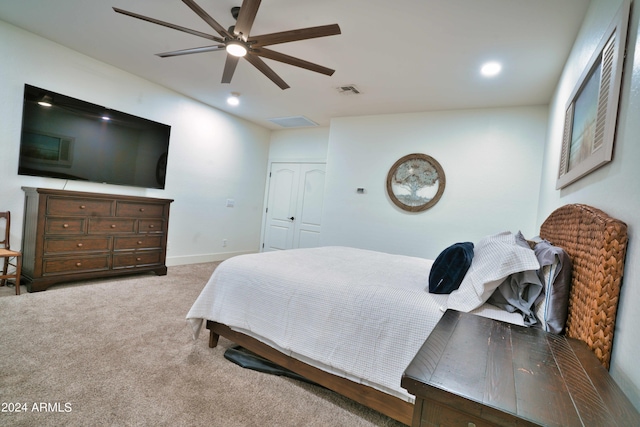 bedroom featuring ceiling fan, a closet, and carpet