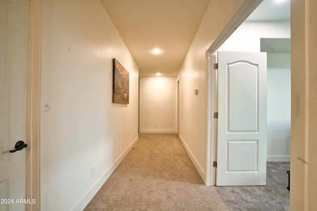 corridor featuring light colored carpet