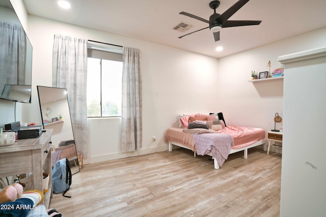 bedroom with ceiling fan and light hardwood / wood-style floors