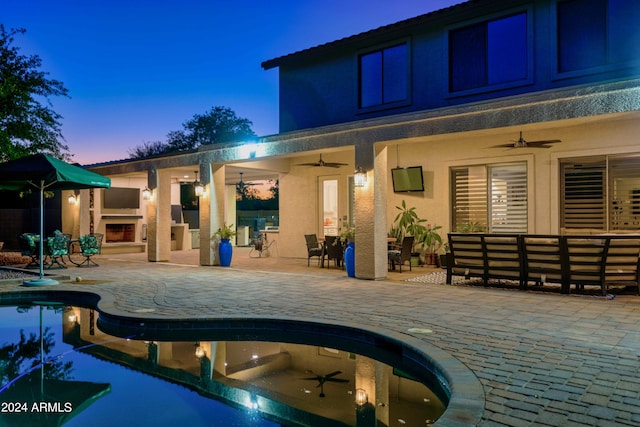 view of pool featuring an outdoor living space with a fireplace, a patio area, and ceiling fan