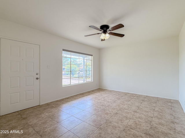 entrance foyer featuring light tile patterned flooring, a ceiling fan, and baseboards