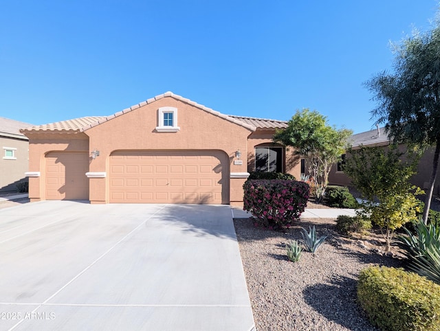 mediterranean / spanish-style house with a garage