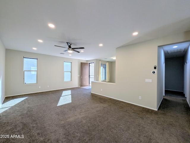 carpeted spare room with ceiling fan