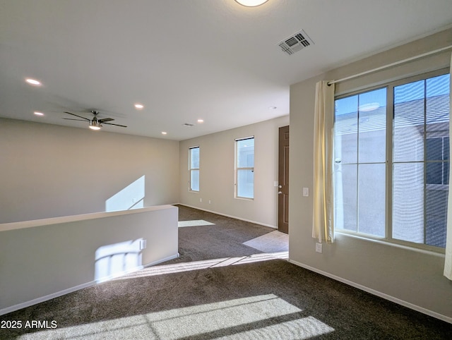 unfurnished room with plenty of natural light and carpet floors