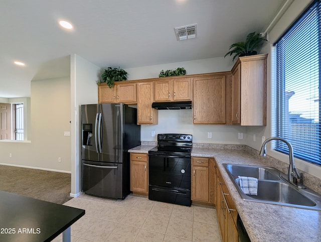 kitchen with fridge with ice dispenser, black range with electric cooktop, light tile patterned floors, and sink