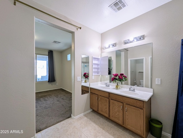 bathroom with vanity, toilet, and tile patterned flooring