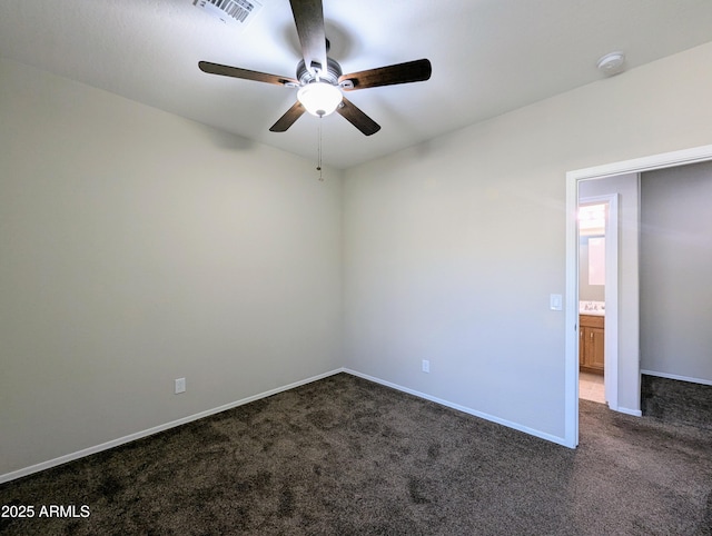 carpeted spare room featuring ceiling fan