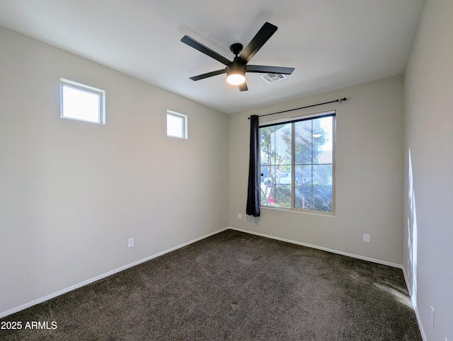 unfurnished room featuring ceiling fan and dark carpet