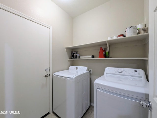 laundry room with separate washer and dryer and light tile patterned floors