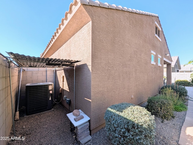 view of side of property featuring central air condition unit