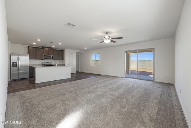 unfurnished living room with recessed lighting, a ceiling fan, visible vents, baseboards, and dark carpet