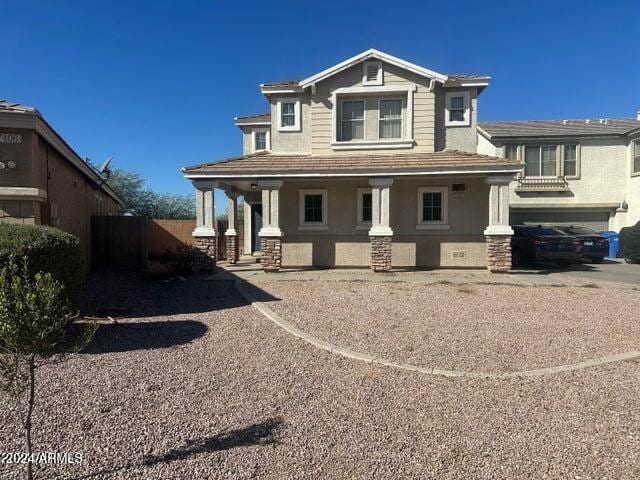 view of front of property featuring a porch and a garage