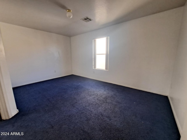 empty room featuring dark carpet