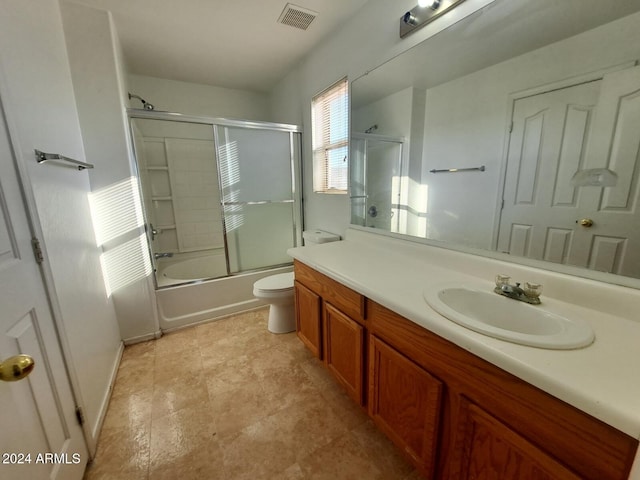 full bathroom featuring vanity, toilet, and enclosed tub / shower combo