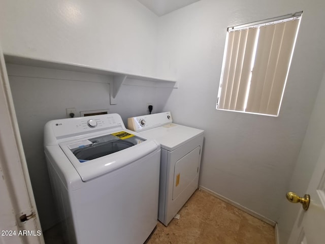 clothes washing area with separate washer and dryer