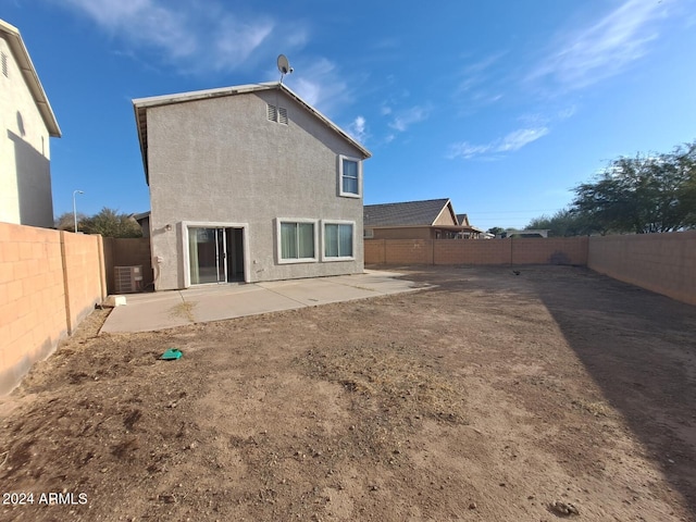 back of property featuring central air condition unit and a patio