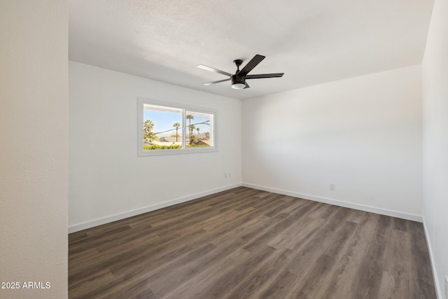 unfurnished room featuring dark wood finished floors, baseboards, and ceiling fan