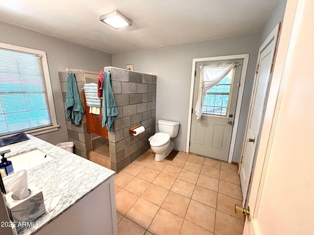 bathroom featuring tile patterned flooring, vanity, and toilet