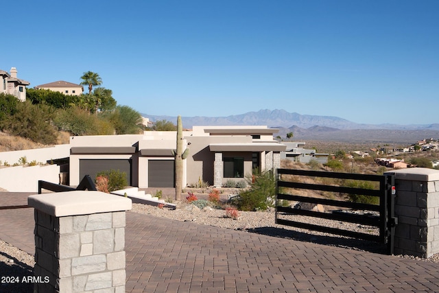 view of front of home with a garage and a mountain view