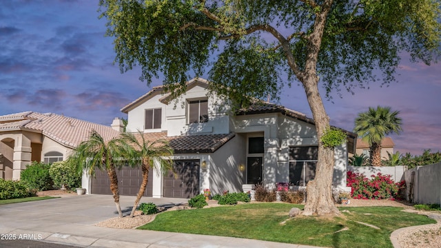 3411 S Vine St, Chandler, AZ 85248 - mediterranean / spanish home featuring concrete driveway, stucco siding, a front lawn, a tiled roof, and fence