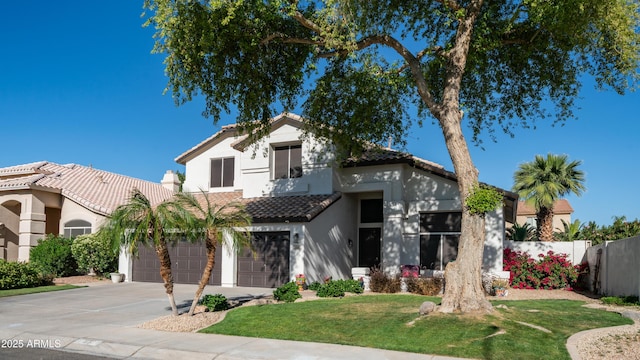 3411 S Vine St, Chandler, AZ 85248 - mediterranean / spanish house with concrete driveway, stucco siding, a front lawn, a tiled roof, and fence