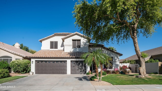 3411 S Vine St, Chandler, AZ 85248 - mediterranean / spanish house featuring a tiled roof, stucco siding, fence, a garage, and concrete driveway