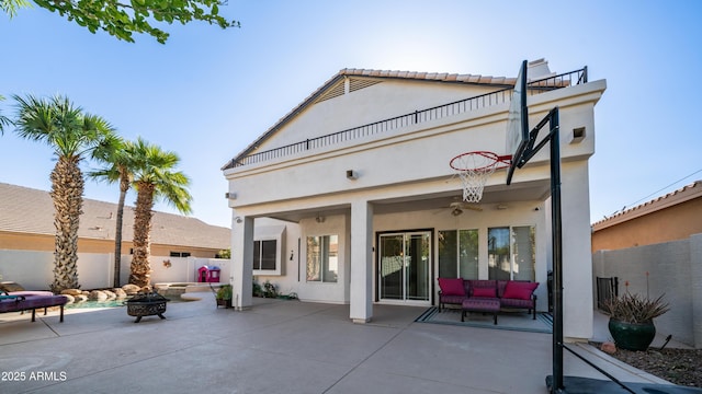 3411 S Vine St, Chandler, AZ 85248 - back of house featuring a balcony, stucco siding, an outdoor living space with a fire pit, a patio area, and fence