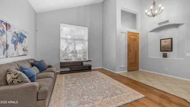 3411 S Vine St, Chandler, AZ 85248 - living room featuring baseboards, high vaulted ceiling, an inviting chandelier, and wood finished floors