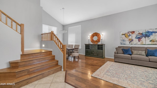 3411 S Vine St, Chandler, AZ 85248 - living area featuring wood finished floors, high vaulted ceiling, baseboards, and stairs