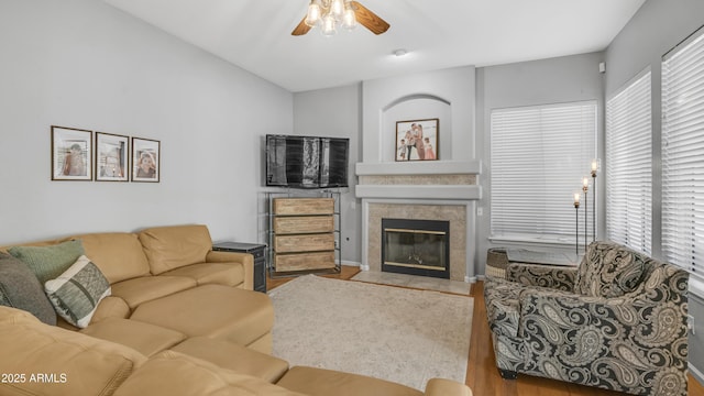 3411 S Vine St, Chandler, AZ 85248 - living room featuring a tiled fireplace, a ceiling fan, wood finished floors, and a healthy amount of sunlight