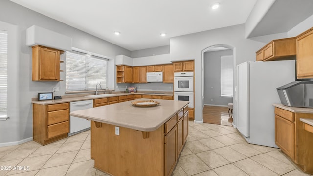 3411 S Vine St, Chandler, AZ 85248 - kitchen featuring light tile patterned floors, white appliances, open shelves, a center island, and a sink