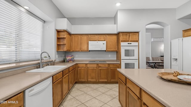 3411 S Vine St, Chandler, AZ 85248 - kitchen with light tile patterned floors, open shelves, arched walkways, a sink, and white appliances