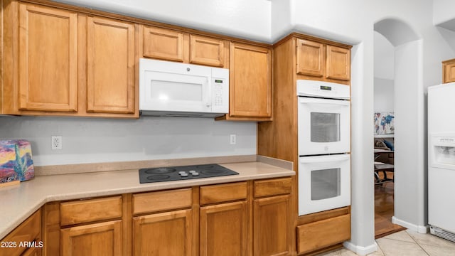 3411 S Vine St, Chandler, AZ 85248 - kitchen with white appliances, light countertops, light tile patterned floors, and brown cabinets