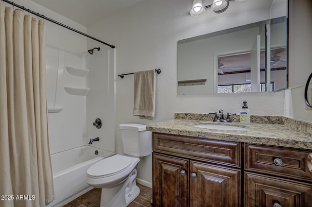 bathroom featuring toilet, vanity, shower / tub combo with curtain, and wood finished floors